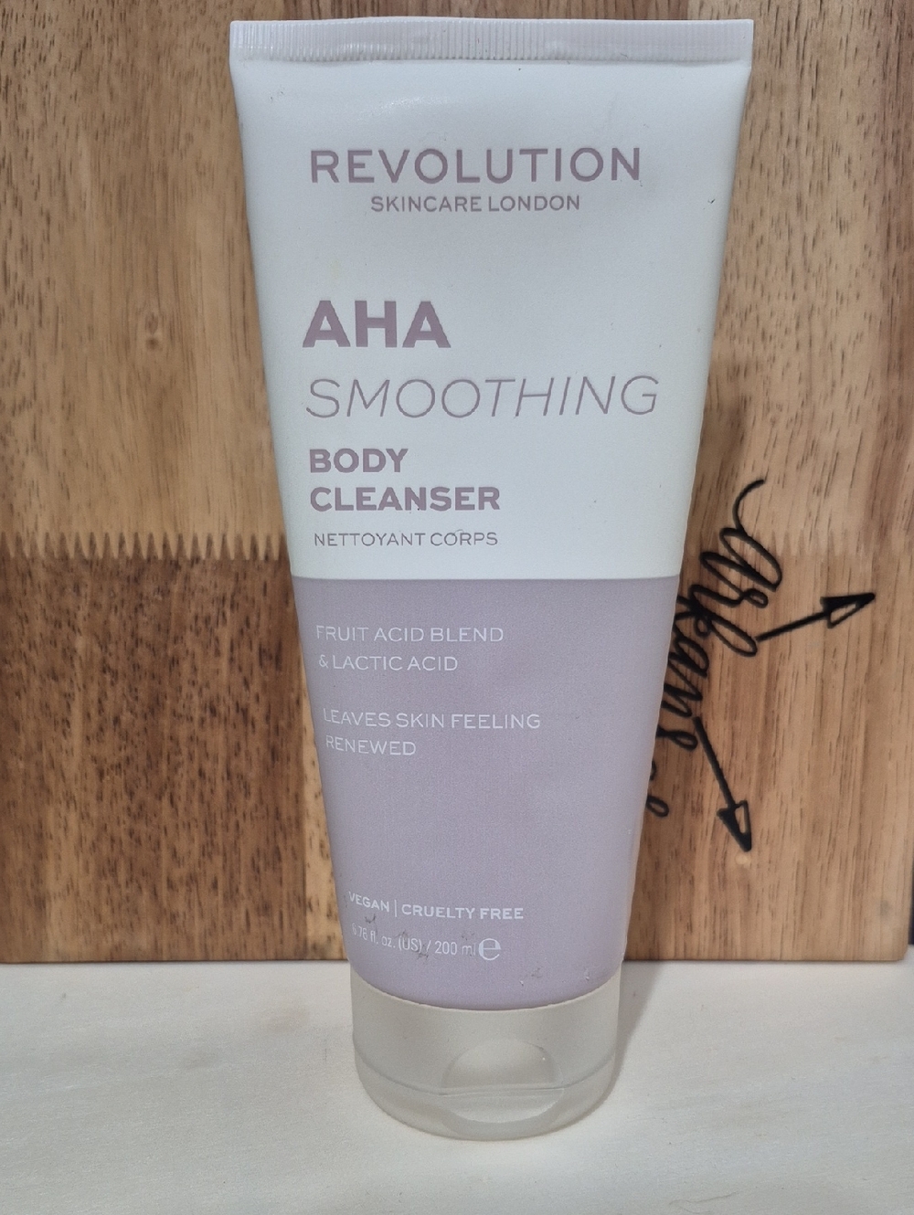 Revolution AHA Smoothing Body Cleanser in lilac and white